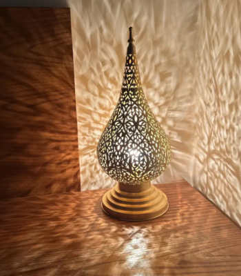 Handcrafted Moroccan brass table lamp with intricate filigree patterns and warm golden glow