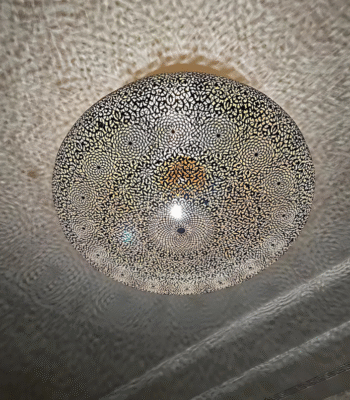 Elegant Moroccan flat brass ceiling light with refined floral engravings and golden ambiance