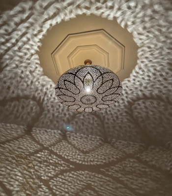 Handcrafted Moroccan brass ceiling light with lotus flower cut-out design projecting floral patterns