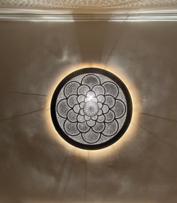 Elegant Moroccan brass wall light with hand-pierced floral bloom mandala pattern and radiant glow